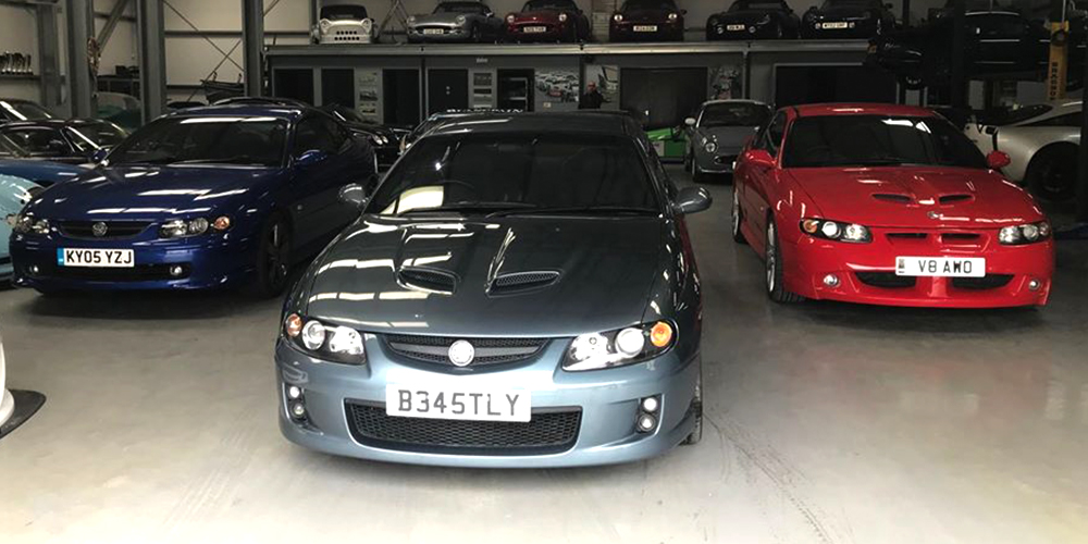 group of vauxhall monaro cars parked in topcats racing workshop