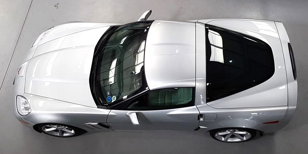 overhead view of silver chevrolet corvette at topcats racing workshop