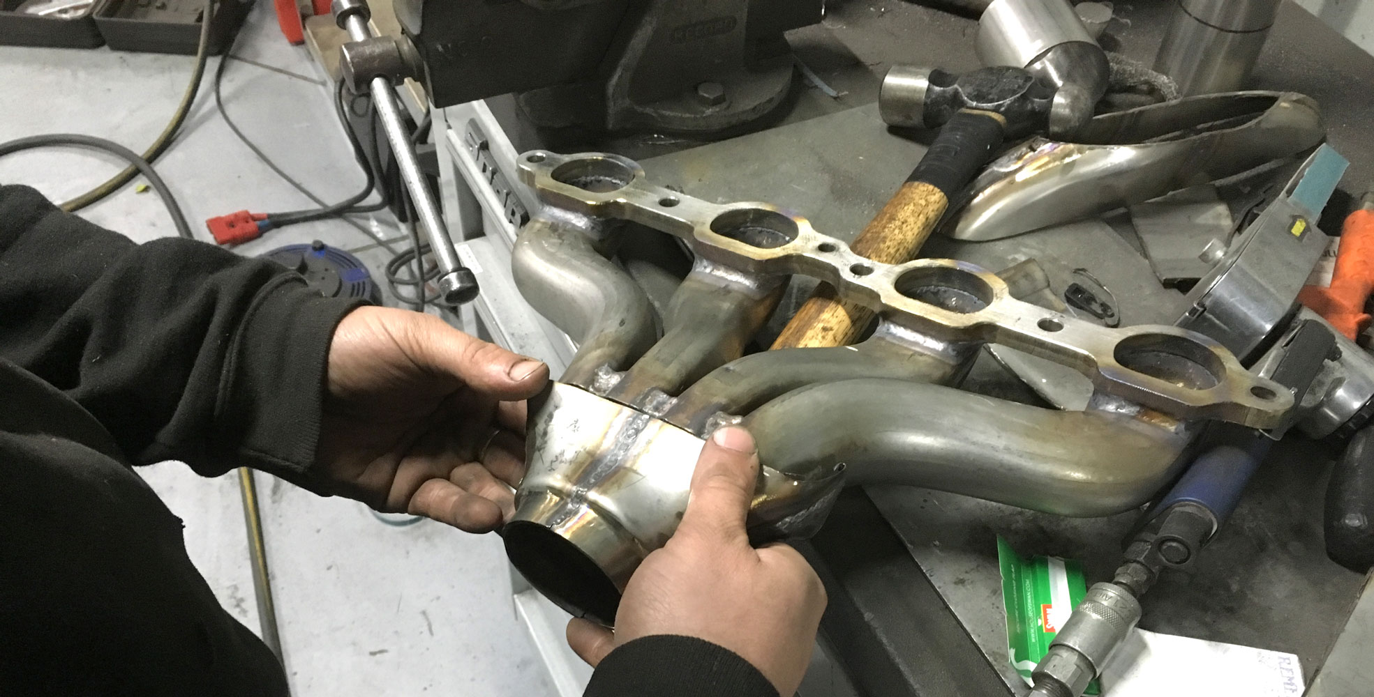 exhaust manifold being modified at topcats racing workshop