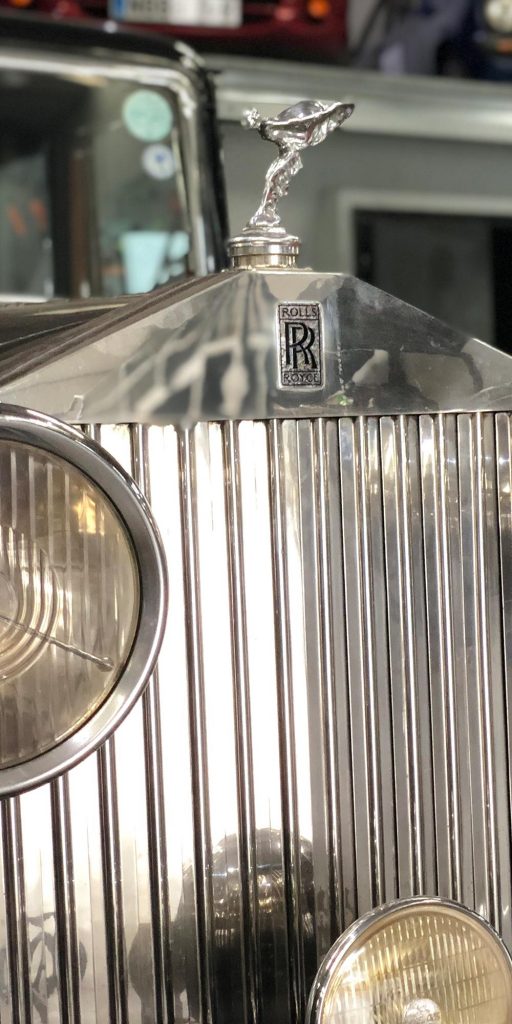 close up of rolls royce radiator grill and emblem