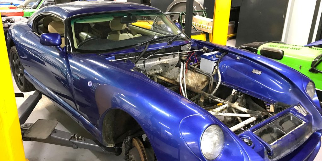 Topcats Racing - Wide New 14 blue tvr cerbera with engine removed on ramp at topcats racing workshop